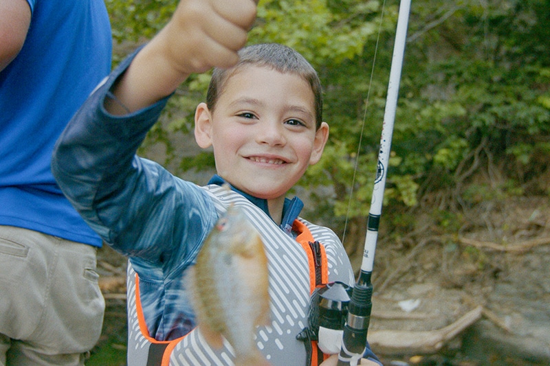 boy holding up fish on fishing line | Russell County, Kentucky